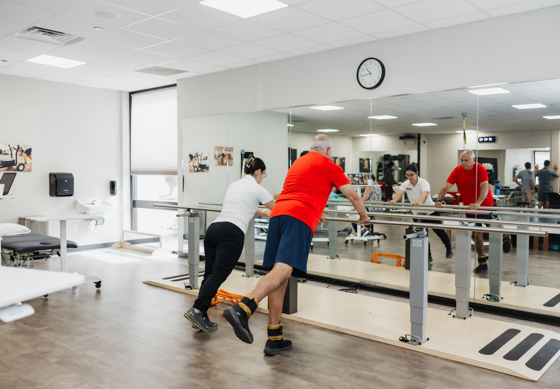 Adult therapy patient performing band exercises at West Texas Rehab to improve strength and mobility.