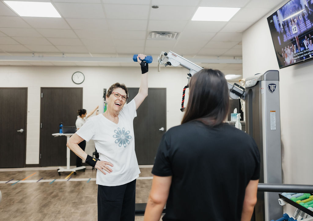 Patient lifting weights at West Texas Rehab to maintain strength and stay active.