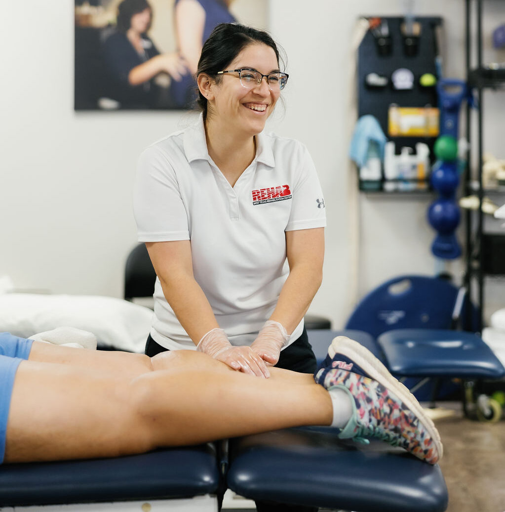 Therapist at West Texas Rehab providing leg rehabilitation therapy for improved mobility and recovery.