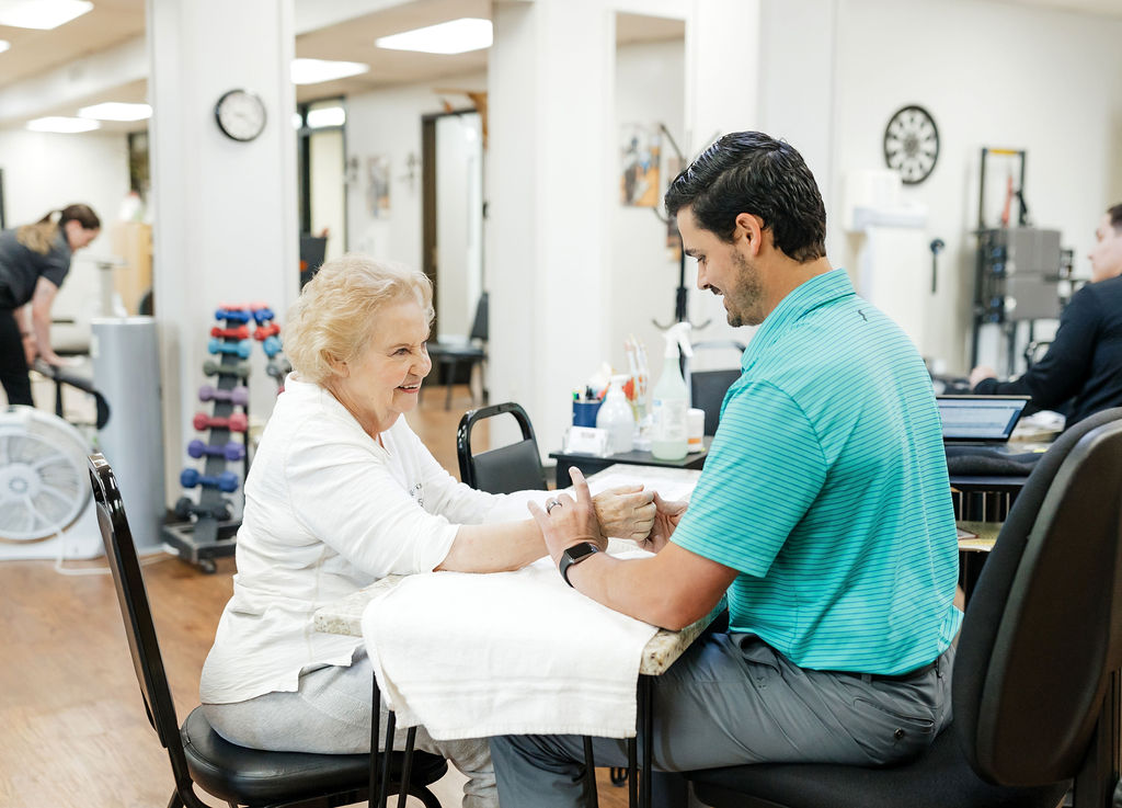 Patient receiving hand therapy at West Texas Rehab to improve hand strength and mobility.