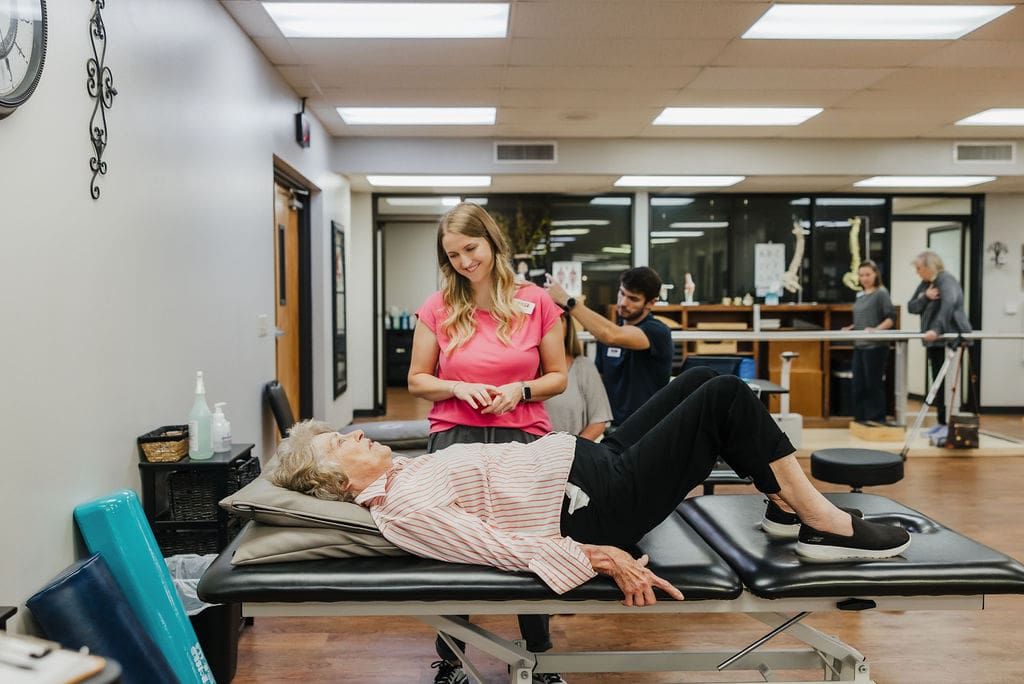 Adult physical therapy patient laying on a therapy table at West Texas Rehab receiving treatment to improve mobility and strength.