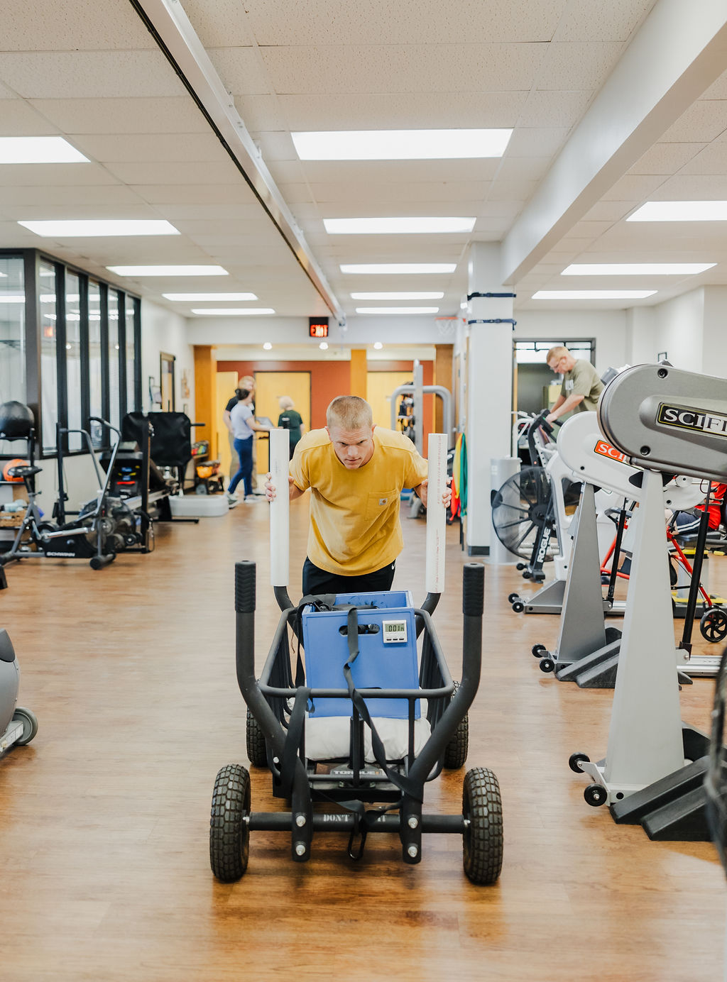 Patient performing work steps testing at West Texas Rehab by moving weights to assess physical readiness for employment.