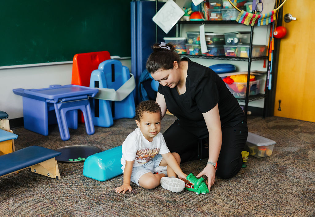 Occupational pediatric therapy patient playing with toys at West Texas Rehab to develop fine motor skills and cognitive abilities.