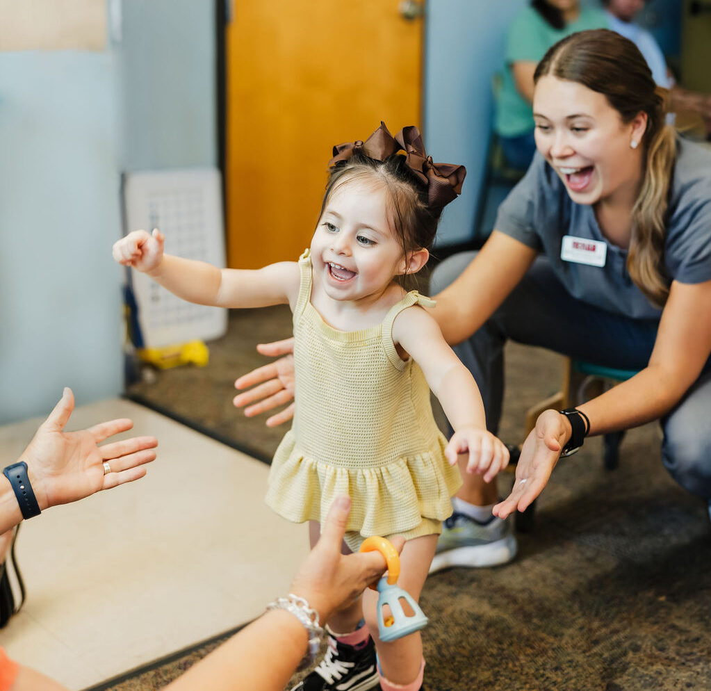 Child walking with a therapist at West Texas Rehab as part of therapy.