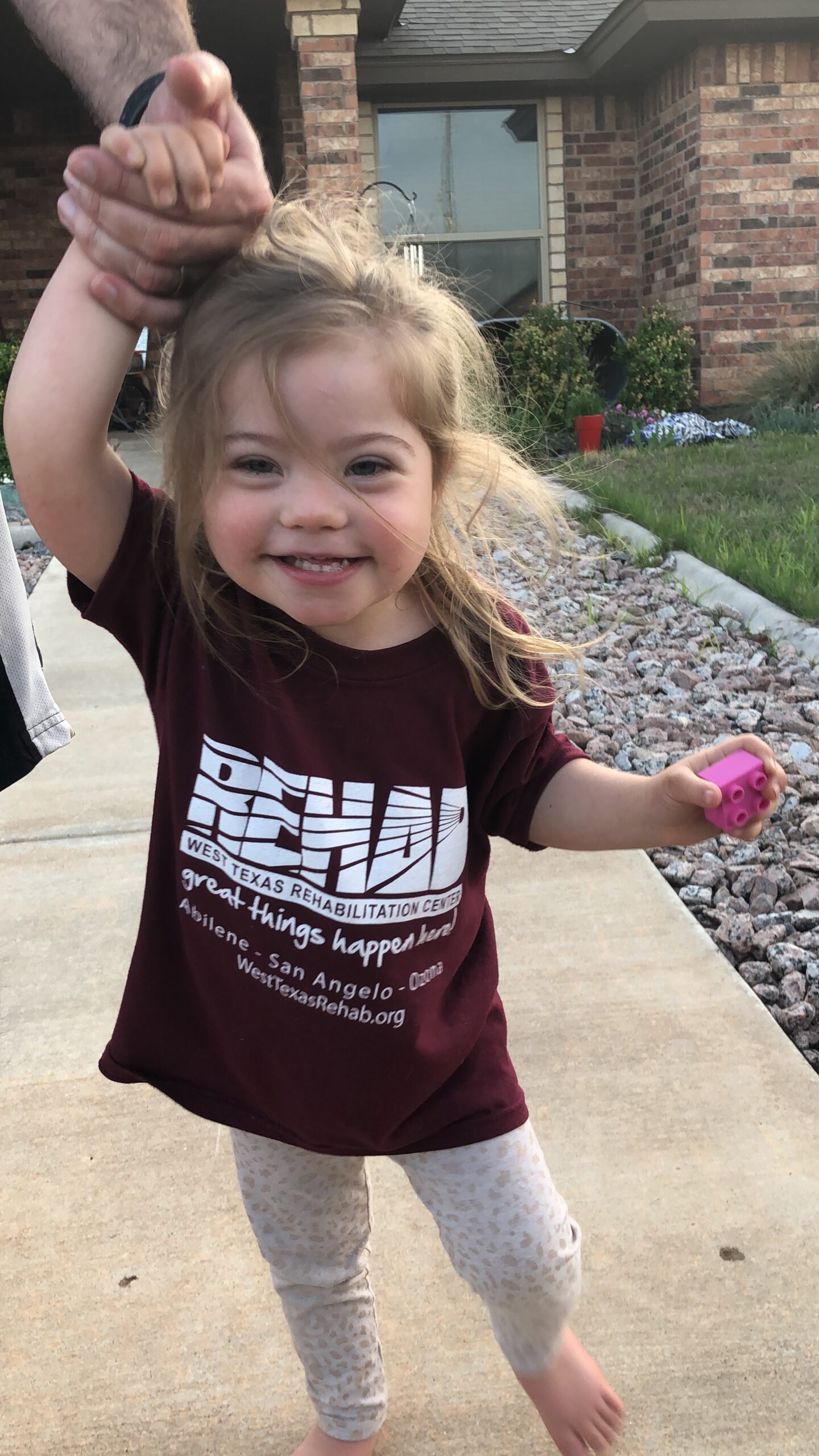 Emma, a pediatric patient at West Texas Rehab, walking during her therapy session to improve mobility.